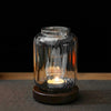 Alternate angle of Wispoak Lantern Warmer on walnut wood surface with tealight lit