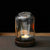 Alternate angle of Wispoak Lantern Warmer on walnut wood surface with tealight lit